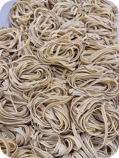 Fresh pasta making with tagliatelle and pici in Umbria