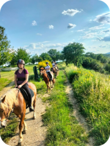 Group enjoying a romantic horseback riding experience in Umbria, Italy