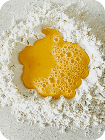 Preparing fresh pasta dough during a cooking class in Umbria