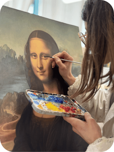 Artisan working on a hand-painted reproduction of the Mona Lisa using traditional restoration techniques in Umbria