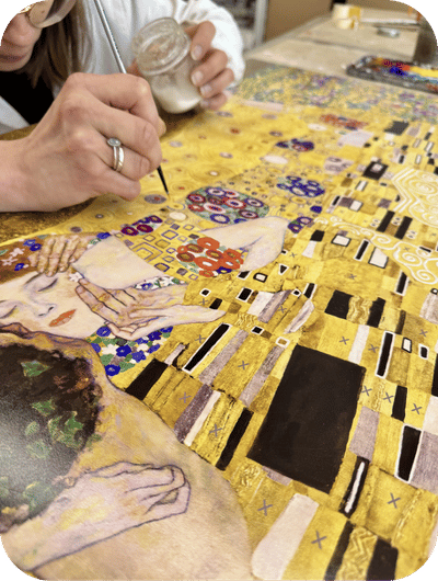 Artisan hands working on traditional painting techniques in an Umbrian workshop