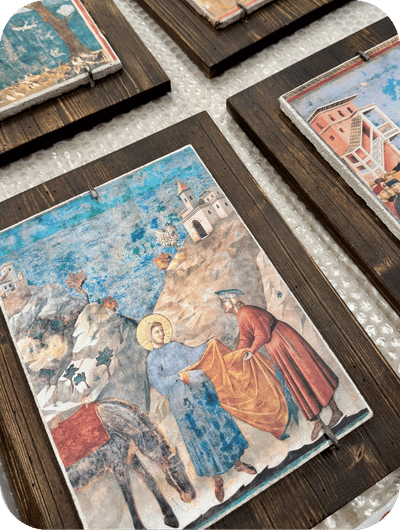 Hand-painted fresco reproduction depicting the life of Saint Francis inside an artisan workshop in Umbria